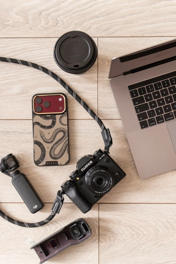Jaye’s camera, phones, filming equipment, laptop and coffee laid out together