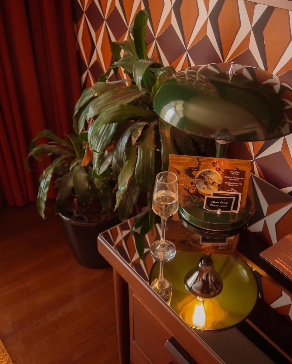 Sparkling wine and a statement lamp in a hotel room, photographed for Jet2