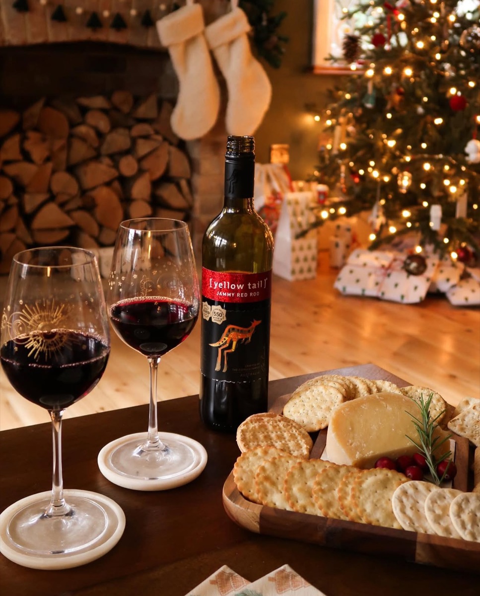 Yellow Tail Jammy Red Roo wine with glasses and a festive cheeseboard