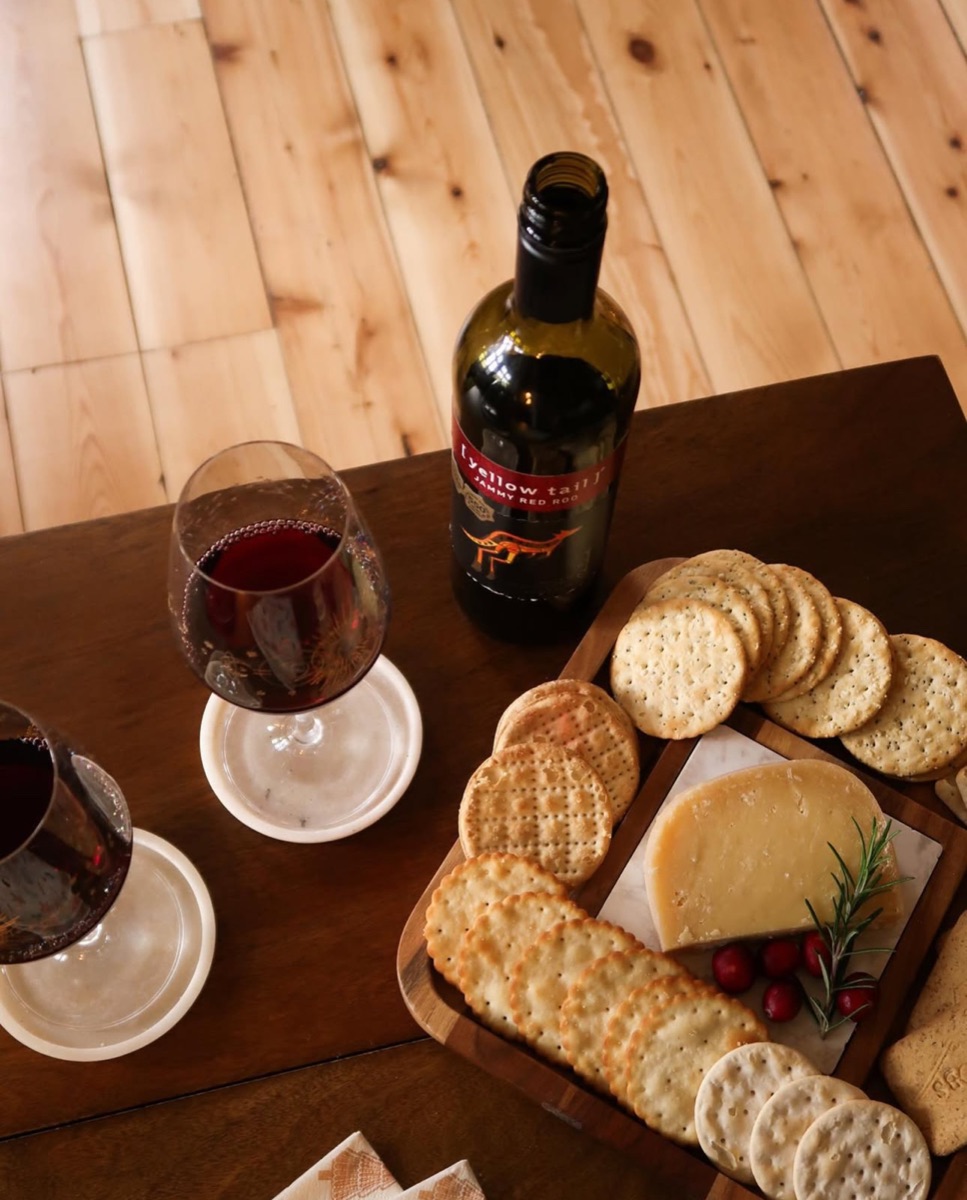 Overhead view of Yellow Tail wine, glasses and a cheeseboard