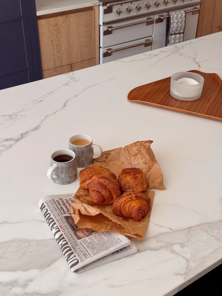 Pastries and coffee on a marble kitchen island