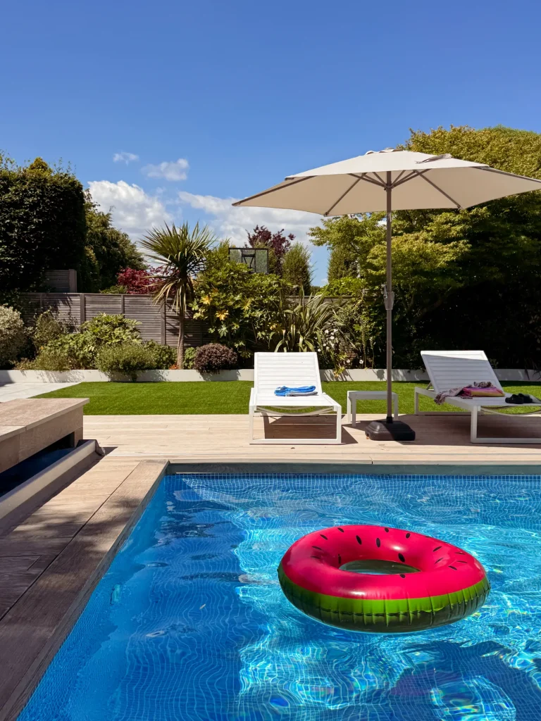 Pink inflatable ring floating in an outdoor pool