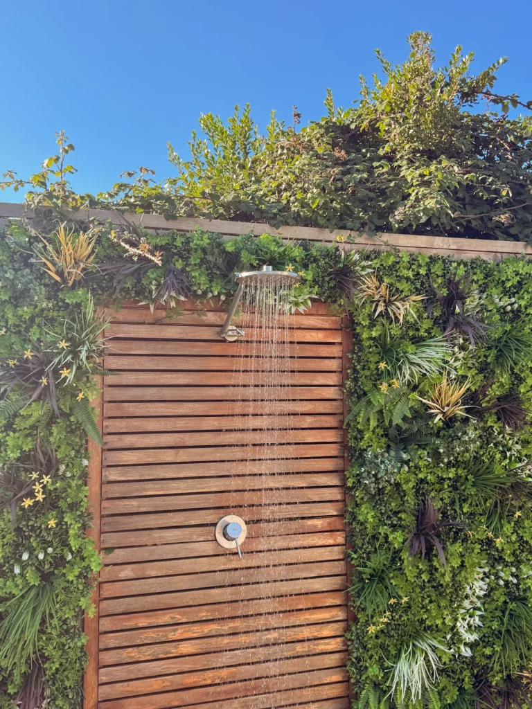 Outdoor shower surrounded by greenery