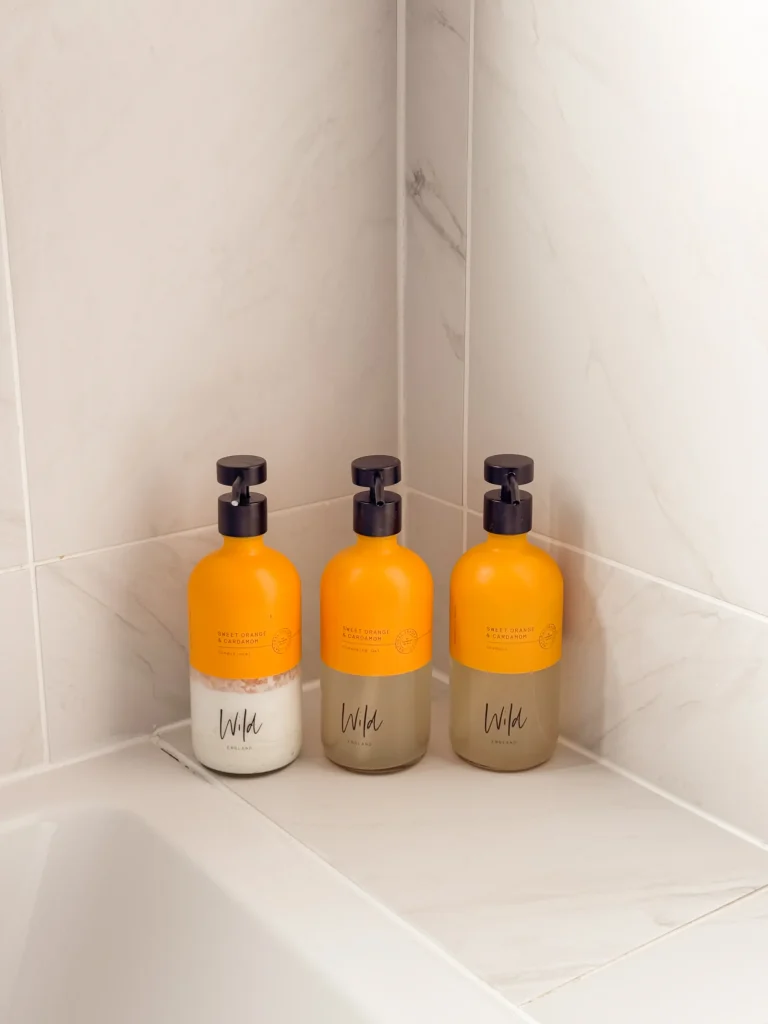 Orange toiletries on a bathroom shelf