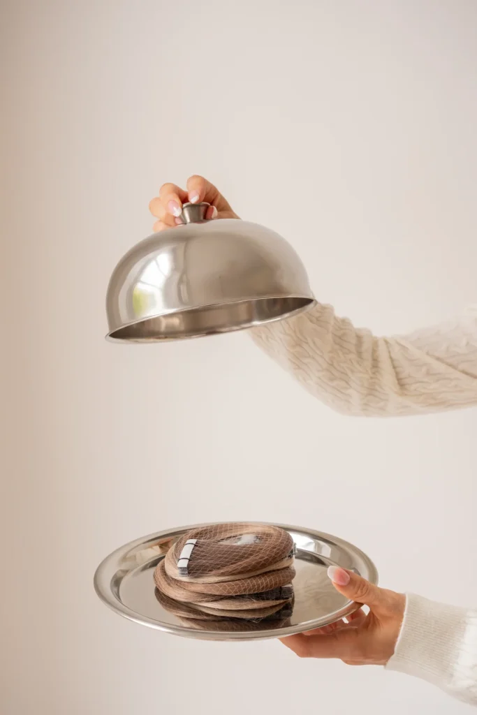 Hair extensions revealed beneath a silver cloche