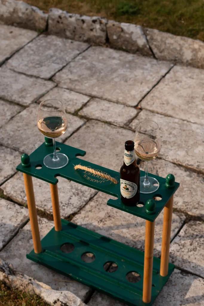 Two glasses and a bottle on an outdoor drinks stand
