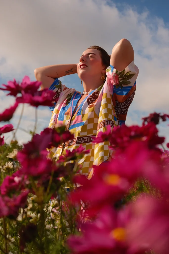 Portrait of a person among pink flowers