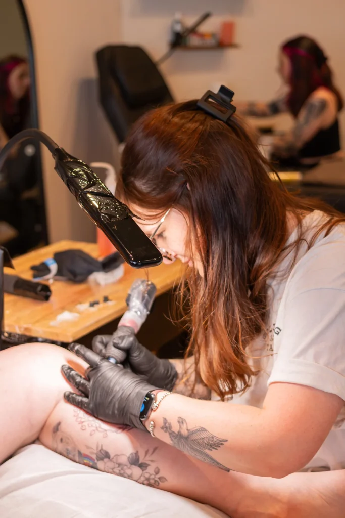 Tattoo artist working on a client in the studio