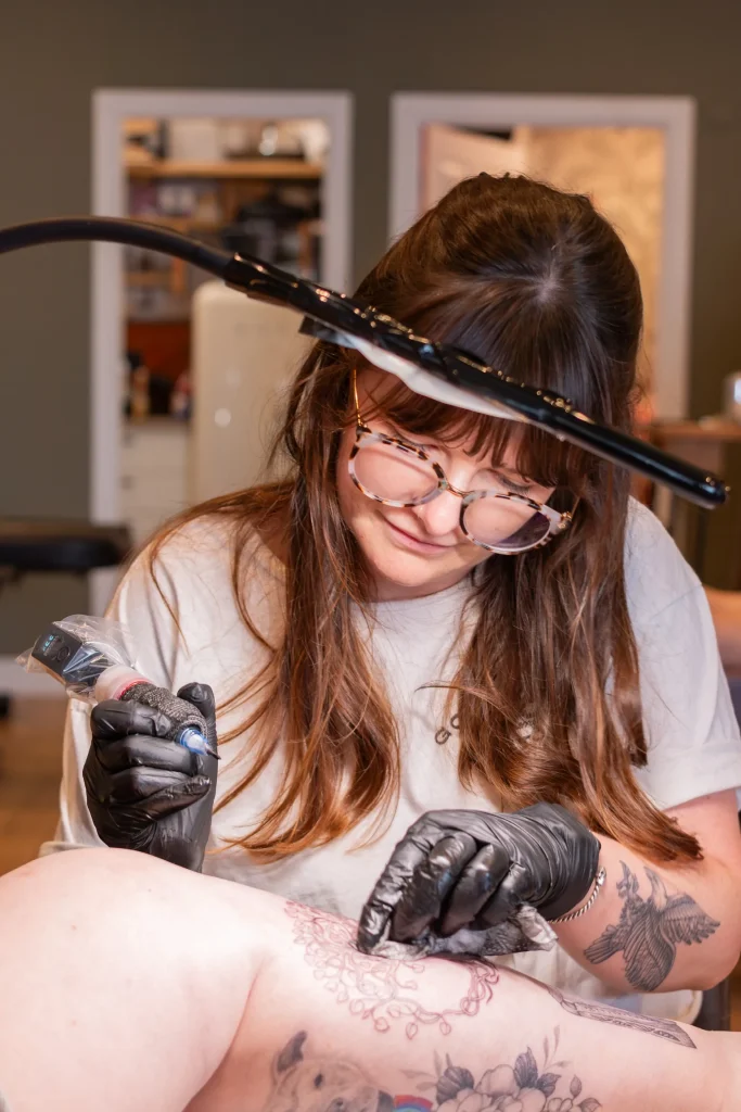 Tattoo artist at work on a detailed design