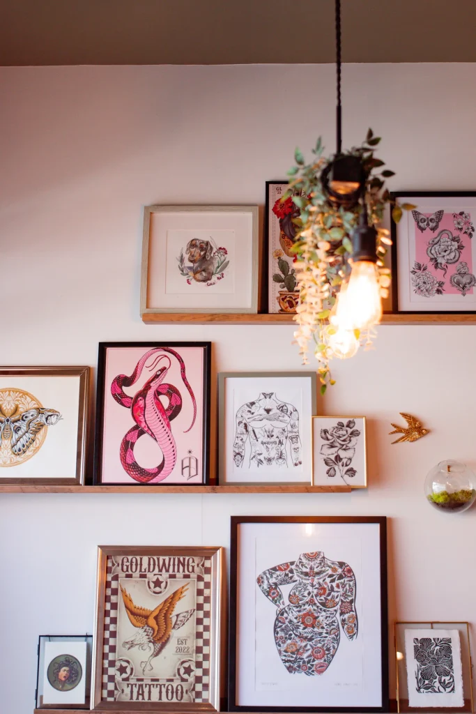Framed tattoo artwork displayed on the studio wall