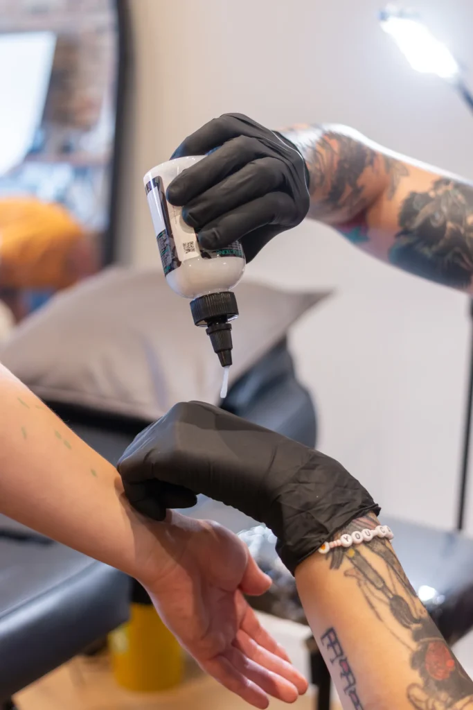 Tattoo artist preparing a client’s skin