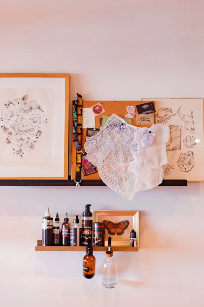 Tattoo designs and supplies displayed in the studio