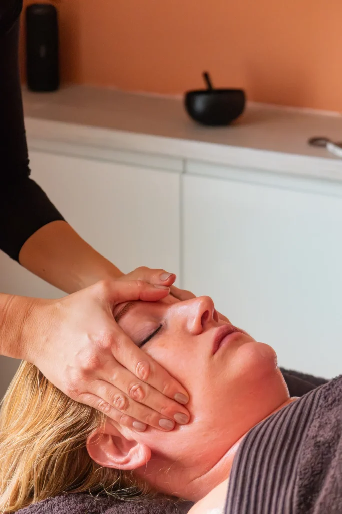 Close-up of hands giving a facial massage treatment