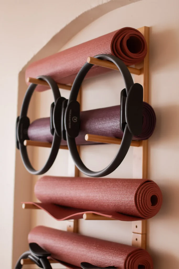 Pilates mats and rings on a studio rack