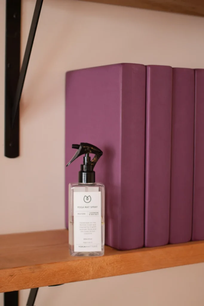 Yoga mat spray beside stacked studio blocks